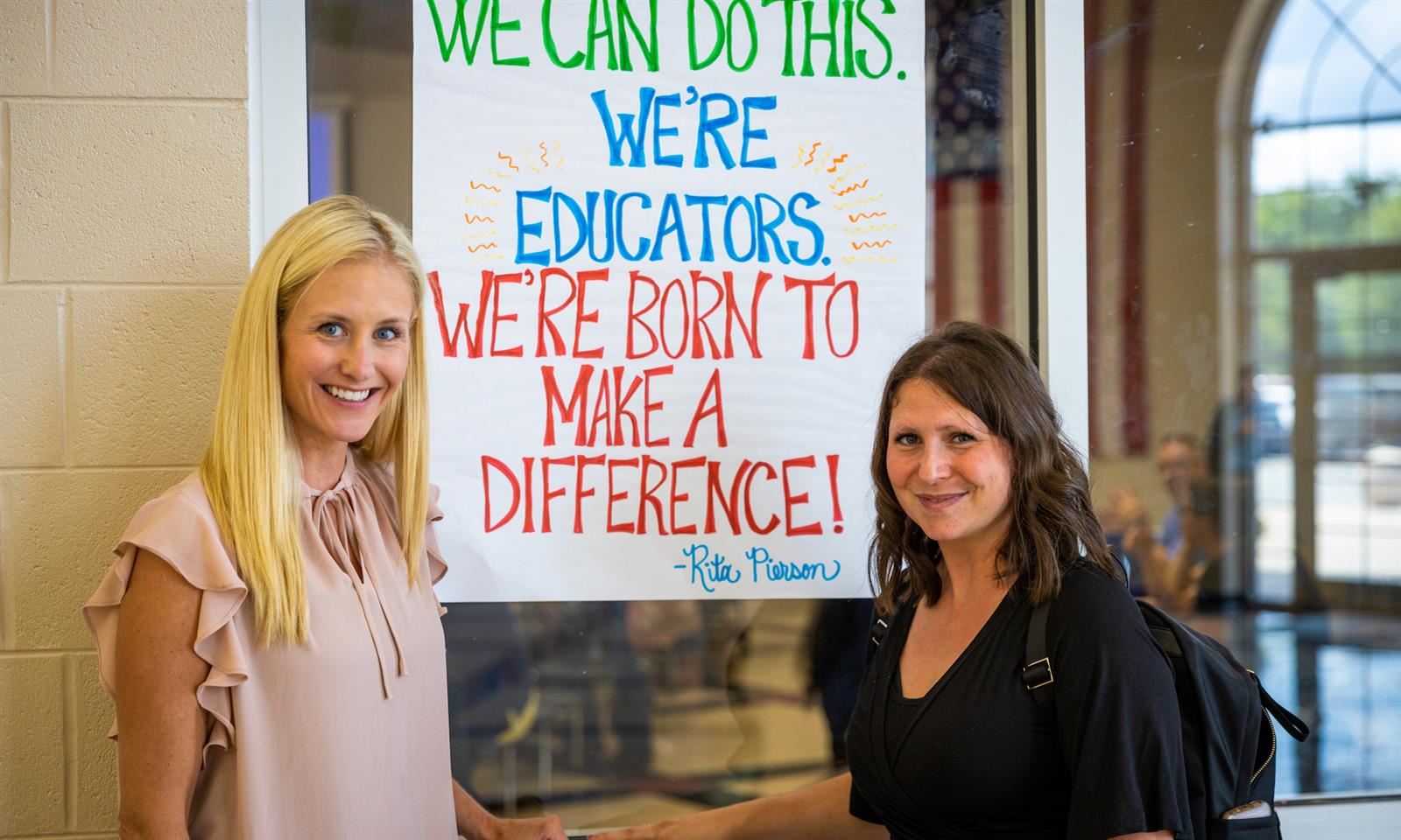 Two teachers smile